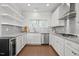 Modern kitchen with white cabinets, subway tile backsplash, and stainless steel appliances at 341 View Dr, Morrisville, NC 27560