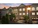 Beautiful townhome exterior featuring brick and siding, illuminated by warm lighting and a sunset sky at 341 View Dr, Morrisville, NC 27560