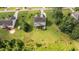 Aerial view of home showing large yard, screened in porch, landscaping and surrounding properties at 3525 Daisy Ln, Wake Forest, NC 27587