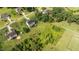 Aerial shot featuring the home nestled on a spacious lot with mature trees and a lush green lawn at 3525 Daisy Ln, Wake Forest, NC 27587