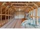 Unfinished attic with wooden beams showing potential for customization and expansion at 3525 Daisy Ln, Wake Forest, NC 27587