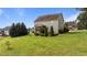 Large, well-maintained lawn in the backyard with mature trees, shrubs, and a screened-in porch at 3525 Daisy Ln, Wake Forest, NC 27587