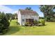 A backyard features a screened-in porch, garden beds, mature trees, and a well-maintained lawn at 3525 Daisy Ln, Wake Forest, NC 27587