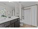 Bathroom with single vanity, framed mirror, tiled floor and shower-tub combination at 3525 Daisy Ln, Wake Forest, NC 27587