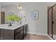 Bathroom vanity with double sinks, tile floor, framed mirror, and a glass enclosed shower at 3525 Daisy Ln, Wake Forest, NC 27587