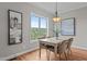 Bright dining room with hardwood floors, large window, and chandelier lighting at 3525 Daisy Ln, Wake Forest, NC 27587