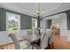 Traditional dining room with gray walls, wainscoting, and a stylish chandelier at 3525 Daisy Ln, Wake Forest, NC 27587