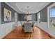 Chic dining room featuring wainscoting, hardwood floors, and modern lighting at 3525 Daisy Ln, Wake Forest, NC 27587