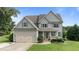 Charming two-story home with gray siding, manicured lawn, and inviting front porch at 3525 Daisy Ln, Wake Forest, NC 27587