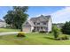 Beautiful two-story home featuring a lush green lawn and mature landscaping at 3525 Daisy Ln, Wake Forest, NC 27587