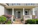 Inviting front porch with stone columns and decorative landscaping at 3525 Daisy Ln, Wake Forest, NC 27587