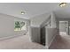 Hallway features carpet flooring, neutral walls, access to an upper level and natural lighting at 3525 Daisy Ln, Wake Forest, NC 27587