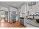 Stainless steel appliances, stone counters and white cabinets in a modern kitchen at 3525 Daisy Ln, Wake Forest, NC 27587