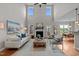 Bright living room with tall ceilings, fireplace, hardwood floors, and stylish furniture at 3525 Daisy Ln, Wake Forest, NC 27587