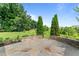 Stone patio surrounded by lush greenery providing an ideal outdoor entertaining space at 3525 Daisy Ln, Wake Forest, NC 27587
