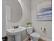 Cozy powder room with pedestal sink, framed mirror and stylish accents at 3525 Daisy Ln, Wake Forest, NC 27587