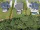 An aerial shows backyards, patios, and pools. A fire pit can be seen in one yard, and a forest in the background at 3829 Sleepy Brook Ln, Apex, NC 27539