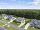 An aerial view showcases the neighborhood featuring manicured lawns and dense tree coverage beyond the homes at 3829 Sleepy Brook Ln, Apex, NC 27539