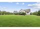 Spacious backyard featuring lush green lawn and a charming patio area perfect for outdoor entertaining at 3829 Sleepy Brook Ln, Apex, NC 27539