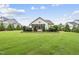Spacious backyard featuring well-maintained lawn, landscaping, and screened porch at 3829 Sleepy Brook Ln, Apex, NC 27539