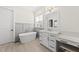Serene bathroom with a soaking tub, vanity with a mirror, and lots of light at 3829 Sleepy Brook Ln, Apex, NC 27539