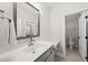 Clean bathroom featuring a sink, vanity with dark wood cabinets, a large framed mirror, and toilet room at 3829 Sleepy Brook Ln, Apex, NC 27539