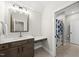 Clean bathroom featuring a vanity with dark wood cabinets, a mirror, and a shower with a curtain at 3829 Sleepy Brook Ln, Apex, NC 27539