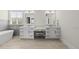 Bright bathroom featuring double sinks, a vanity area, and a standalone tub at 3829 Sleepy Brook Ln, Apex, NC 27539