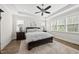 Cozy bedroom with tray ceiling, plush bed, and natural light from multiple windows at 3829 Sleepy Brook Ln, Apex, NC 27539