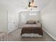Well-lit bedroom with a comfortable bed, side tables, soft carpet, and bright natural light at 3829 Sleepy Brook Ln, Apex, NC 27539