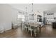 Charming dining area with wooden table, elegant lighting and view to the kitchen at 3829 Sleepy Brook Ln, Apex, NC 27539