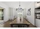 Beautiful dining room with rustic wood table, chandelier lighting, and lovely butterfly art at 3829 Sleepy Brook Ln, Apex, NC 27539