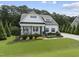 Inviting home with a cozy front porch, manicured lawn, and tasteful landscaping creating excellent curb appeal at 3829 Sleepy Brook Ln, Apex, NC 27539