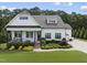 Charming exterior view of a well-maintained home with pristine landscaping, a cozy porch, and a side entry garage at 3829 Sleepy Brook Ln, Apex, NC 27539