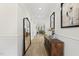 Elegant foyer with hardwood floors, decorative mirror, and a stylish console table, creating a welcoming entrance at 3829 Sleepy Brook Ln, Apex, NC 27539