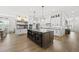 Expansive kitchen showcasing a large island with seating, modern appliances, and open layout to dining area at 3829 Sleepy Brook Ln, Apex, NC 27539