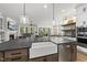Bright, open kitchen featuring a large island, farmhouse sink, modern appliances and an open flow to the living and dining areas at 3829 Sleepy Brook Ln, Apex, NC 27539