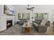 Inviting living room with a fireplace, large windows, comfortable seating, and an open layout at 3829 Sleepy Brook Ln, Apex, NC 27539