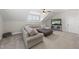 Comfortable upstairs living room featuring a cozy sectional, storage cabinet, and a large ottoman at 3829 Sleepy Brook Ln, Apex, NC 27539