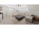 Well-lit upstairs living room featuring cozy seating, a large ottoman, and built-in shelving at 3829 Sleepy Brook Ln, Apex, NC 27539