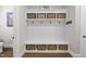 Charming mudroom with built-in storage, shelving, and bench seating with decorative baskets at 3829 Sleepy Brook Ln, Apex, NC 27539