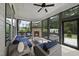 Inviting screened porch with fireplace, TV, comfortable seating, and views of backyard at 3829 Sleepy Brook Ln, Apex, NC 27539
