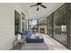 Inviting screened porch with fireplace, TV, comfortable seating, and views of backyard at 3829 Sleepy Brook Ln, Apex, NC 27539