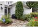 Charming backyard with stone patio, landscaping, and access to a screened porch at 3902 Stags Leap Cir, Raleigh, NC 27612