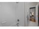 Bright bathroom featuring a clean, tiled shower and a glimpse into an adjacent bedroom at 3902 Stags Leap Cir, Raleigh, NC 27612
