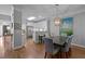 Open dining room with view to kitchen, neutral color palette, and hardwood floors at 3902 Stags Leap Cir, Raleigh, NC 27612