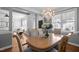 Bright dining area features hardwood floors, a chandelier, and a large window for natural light at 3902 Stags Leap Cir, Raleigh, NC 27612