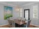 Well decorated dining room with modern chandelier and decorative window shades at 3902 Stags Leap Cir, Raleigh, NC 27612