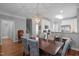 Open dining room with hardwood floors, view of kitchen, and elegant decor at 3902 Stags Leap Cir, Raleigh, NC 27612