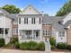 Charming two-story townhome with brick and white siding, a covered porch, and landscaped front yard at 3902 Stags Leap Cir, Raleigh, NC 27612